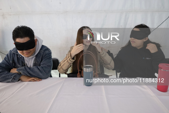 A group of blind people and volunteers meet at the Guide Dog Training School for the Blind (I.A.P) in Mexico City, Mexico, on December 20, 2...