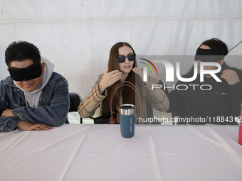 A group of blind people and volunteers meet at the Guide Dog Training School for the Blind (I.A.P) in Mexico City, Mexico, on December 20, 2...