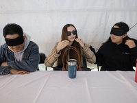 A group of blind people and volunteers meet at the Guide Dog Training School for the Blind (I.A.P) in Mexico City, Mexico, on December 20, 2...