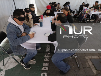 A group of blind people and volunteers meet at the Guide Dog Training School for the Blind (I.A.P) in Mexico City, Mexico, on December 20, 2...