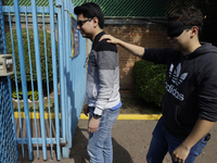 Blind people attend a meeting at the Guide Dog Training School for the Blind (I.A.P) in Mexico City, Mexico, on December 20, 2024. The schoo...