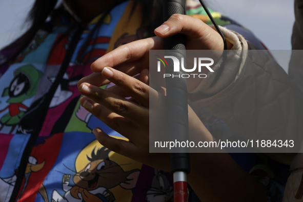 Blind women hold hands during a meeting at the Guide Dogs for the Blind Training School I.A.P in Mexico City, Mexico. The school provides in...