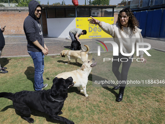 A group of blind people and volunteers meet at the Guide Dog Training School for the Blind (I.A.P) in Mexico City, Mexico, on December 20, 2...