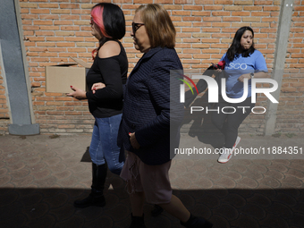 Silvia Lozada Badillo (center) is the director and founder of the Guide Dogs for the Blind Training School I.A.P in Mexico City, Mexico. The...