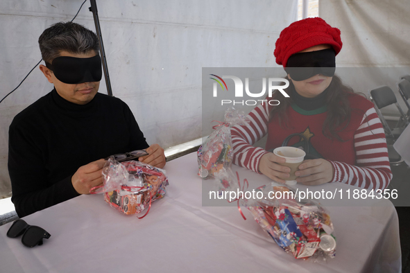 A group of blind people and volunteers meet at the Guide Dog Training School for the Blind (I.A.P) in Mexico City, Mexico, on December 20, 2...