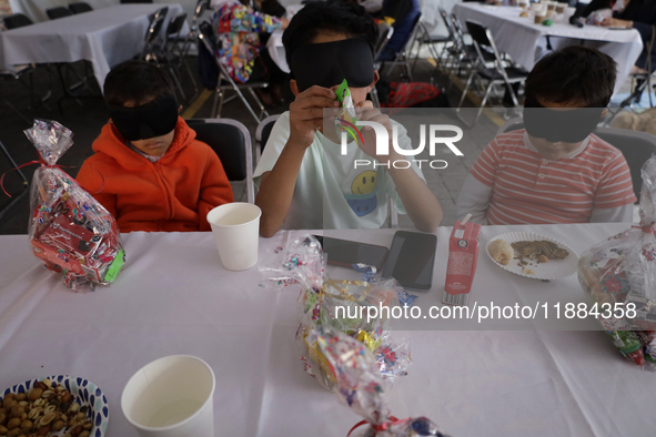 A group of blind people and volunteers meet at the Guide Dog Training School for the Blind (I.A.P) in Mexico City, Mexico, on December 20, 2...