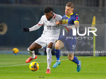 Emerson Royal of AC Milan plays against Tomas Suslov of Hellas Verona during the Italian Serie A Enilive soccer championship match between H...