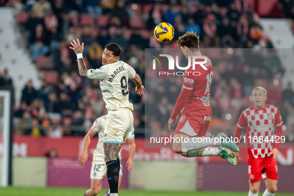 In Girona, Spain, on December 20, 2024, Marcos Andre of Real Valladolid and Ladislav Krejci of Girona FC compete for the ball during the LaL...