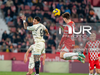 In Girona, Spain, on December 20, 2024, Marcos Andre of Real Valladolid and Ladislav Krejci of Girona FC compete for the ball during the LaL...