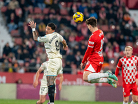 In Girona, Spain, on December 20, 2024, Marcos Andre of Real Valladolid and Ladislav Krejci of Girona FC compete for the ball during the LaL...