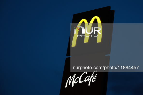 McDonald's and McCafe logos are seen near the restaurant in Poland on December 20, 2024. 