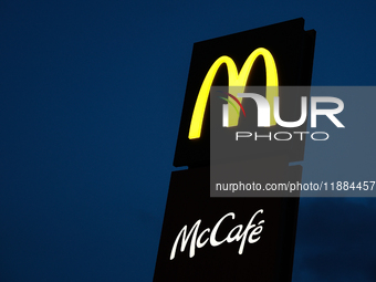 McDonald's and McCafe logos are seen near the restaurant in Poland on December 20, 2024. (