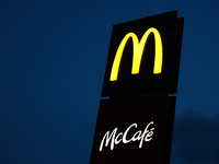 McDonald's and McCafe logos are seen near the restaurant in Poland on December 20, 2024. (