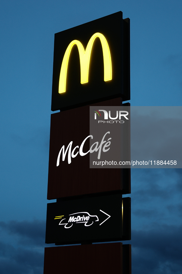 McDonald's, McCafe and McDrive logos are seen near the restaurant in Poland on December 20, 2024. 