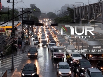 A storm hits the south zone of Sao Paulo in the region of the Joao Dias terminal in Sao Paulo, Brazil, on December 20, 2024, causing traffic...