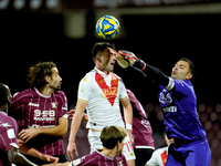 Luigi Sepe of US Salernitana and Gabriele Moncini of Brescia Calcio jump for the ball during the Serie BKT match between US Salernitana and...