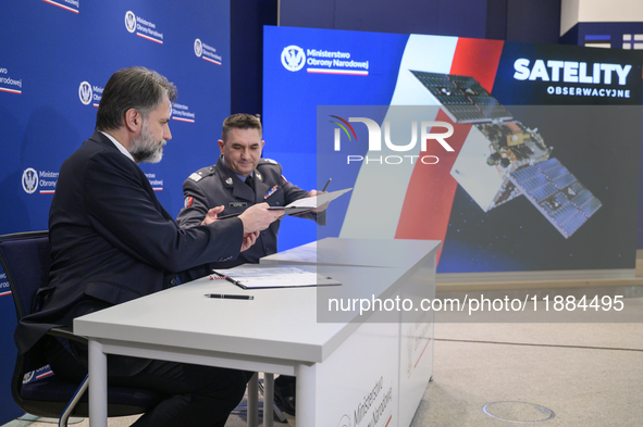 President of the Management Board of Creotech Instruments S.A., Grzegorz Brona (L), and the chief of the Polish Armament Agency, Artur Kupte...