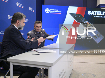 President of the Management Board of Creotech Instruments S.A., Grzegorz Brona (L), and the chief of the Polish Armament Agency, Artur Kupte...