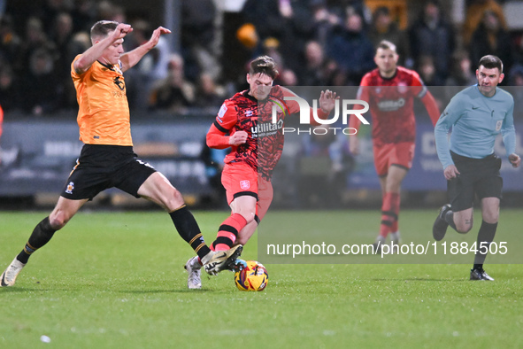 Michael Morrison (5, Cambridge United) challenges Ben Wiles (8, Huddersfield) during the Sky Bet League 1 match between Cambridge United and...