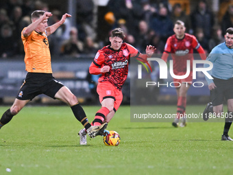 Michael Morrison (5, Cambridge United) challenges Ben Wiles (8, Huddersfield) during the Sky Bet League 1 match between Cambridge United and...