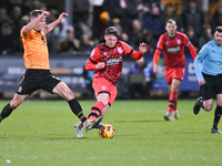 Michael Morrison (5, Cambridge United) challenges Ben Wiles (8, Huddersfield) during the Sky Bet League 1 match between Cambridge United and...