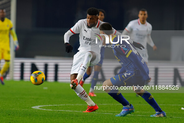 Emerson Royal of AC Milan plays against Diego Coppola of Hellas Verona during the Italian Serie A Enilive soccer championship match between...