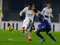 Emerson Royal of AC Milan plays against Diego Coppola of Hellas Verona during the Italian Serie A Enilive soccer championship match between...