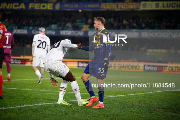 Ondrej Duda of Hellas Verona and Tommy Abraham of AC Milan participate in the Italian Serie A Enilive soccer championship football match bet...