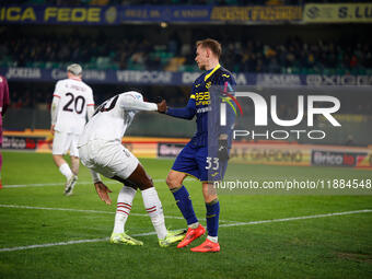 Ondrej Duda of Hellas Verona and Tommy Abraham of AC Milan participate in the Italian Serie A Enilive soccer championship football match bet...