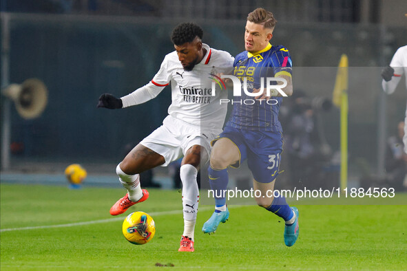 Emerson Royal of AC Milan plays against Tomas Suslov of Hellas Verona during the Italian Serie A Enilive soccer championship match between H...