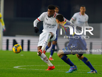 Emerson Royal of AC Milan plays against Diego Coppola of Hellas Verona during the Italian Serie A Enilive soccer championship match between...