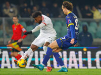 Emerson Royal of AC Milan plays against Daniele Ghilardi of Hellas Verona during the Italian Serie A Enilive soccer championship match betwe...