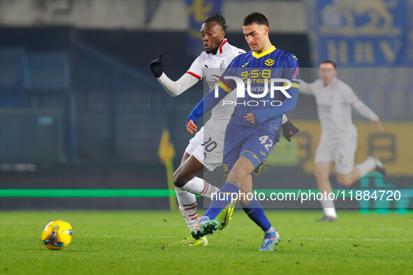 Diego Coppola of Hellas Verona plays against Tommy Abraham of AC Milan during the Italian Serie A Enilive soccer championship match between...