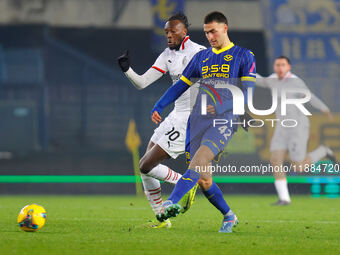 Diego Coppola of Hellas Verona plays against Tommy Abraham of AC Milan during the Italian Serie A Enilive soccer championship match between...