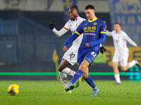 Diego Coppola of Hellas Verona plays against Tommy Abraham of AC Milan during the Italian Serie A Enilive soccer championship match between...