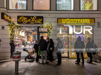 People on the street for window shopping and buying presents in Munich, Bavaria, Germany, on December 20, 2024 (