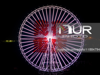 The 120-meter-high ''Chongqing Eye Ferris Wheel'' in Happy Valley opens for operation after an upgrade in Chongqing, China, on December 20,...