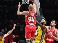 Evan Fournier of Olympiacos Piraeus competes with Trevion Williams of Alba Berlin during the Euroleague, Round 17 match between Olympiacos P...