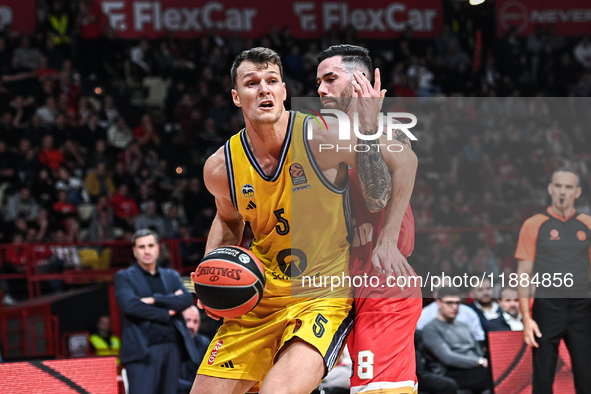 Yanni Wetzell of Alba Berlin competes with Luca Vildoza of Olympiacos Piraeus during the Euroleague, Round 17 match between Olympiacos Pirae...