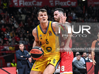 Yanni Wetzell of Alba Berlin competes with Luca Vildoza of Olympiacos Piraeus during the Euroleague, Round 17 match between Olympiacos Pirae...