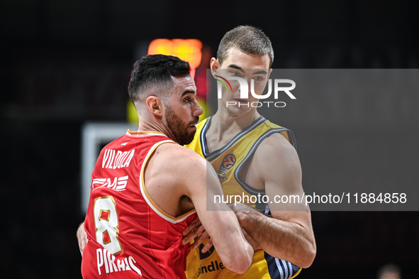 Luca Vildoza of Olympiacos Piraeus competes with Ziga Samar of Alba Berlin during the Euroleague, Round 17 match between Olympiacos Piraeus...