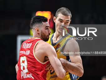 Luca Vildoza of Olympiacos Piraeus competes with Ziga Samar of Alba Berlin during the Euroleague, Round 17 match between Olympiacos Piraeus...