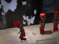 Three Iranian performers wear masks and red dresses as Hajji Firuz, an Iranian New Year symbol, and dance during Yalda Night celebrations at...