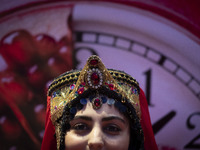 A young Iranian woman wearing a traditional hat poses for a photograph after performing in Yalda Night celebrations at the Iran Mall shoppin...