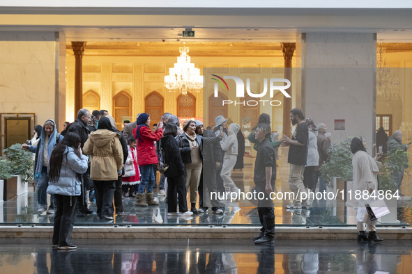 Iranian families visit the Iran Mall shopping mall in northwestern Tehran, Iran, on December 20, 2024, during Yalda Night celebrations. Yald...