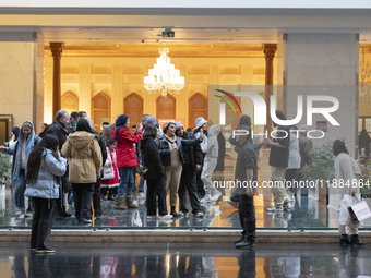 Iranian families visit the Iran Mall shopping mall in northwestern Tehran, Iran, on December 20, 2024, during Yalda Night celebrations. Yald...