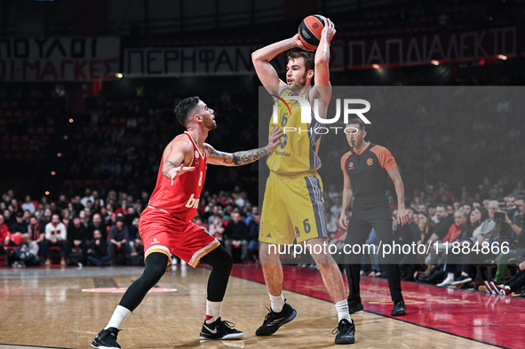 Malte Delow of Alba Berlin competes with Luca Vildoza of Olympiacos Piraeus during the Euroleague, Round 17 match between Olympiacos Piraeus...