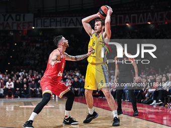 Malte Delow of Alba Berlin competes with Luca Vildoza of Olympiacos Piraeus during the Euroleague, Round 17 match between Olympiacos Piraeus...