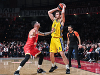 Malte Delow of Alba Berlin competes with Luca Vildoza of Olympiacos Piraeus during the Euroleague, Round 17 match between Olympiacos Piraeus...