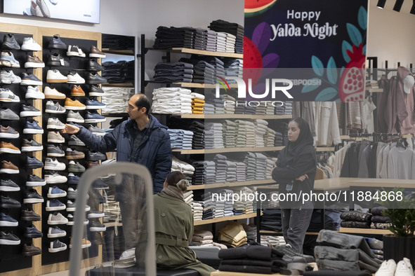 A young Iranian couple shops during Yalda Night celebrations at the Iran Mall shopping mall in northwestern Tehran, Iran, on December 20, 20...